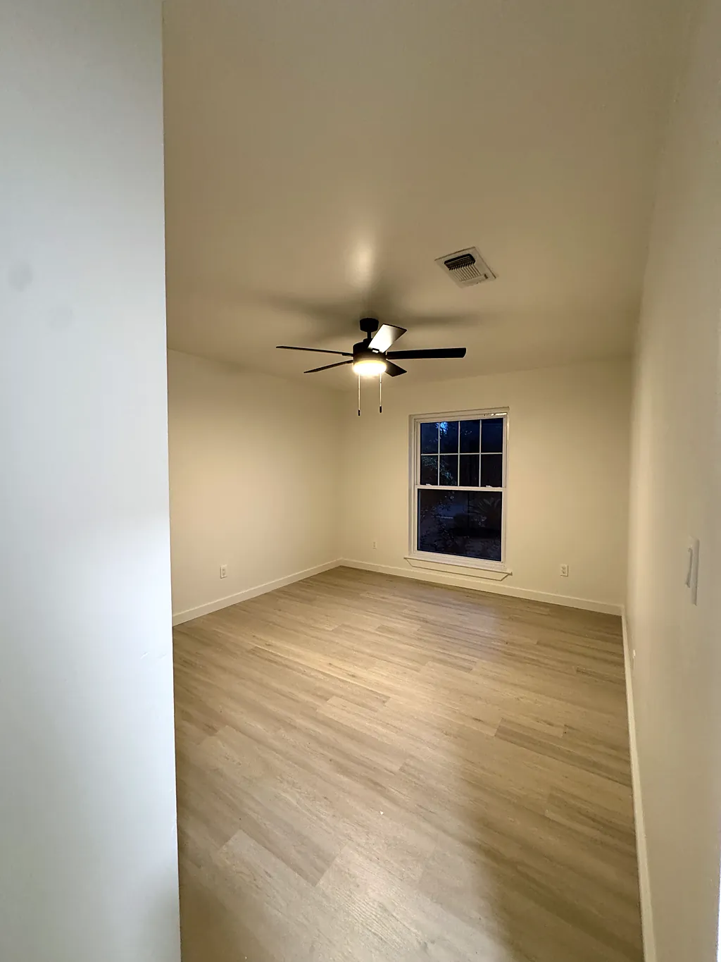 Freshly painted bedroom with white trim and a repainted ceiling in Destin, Florida