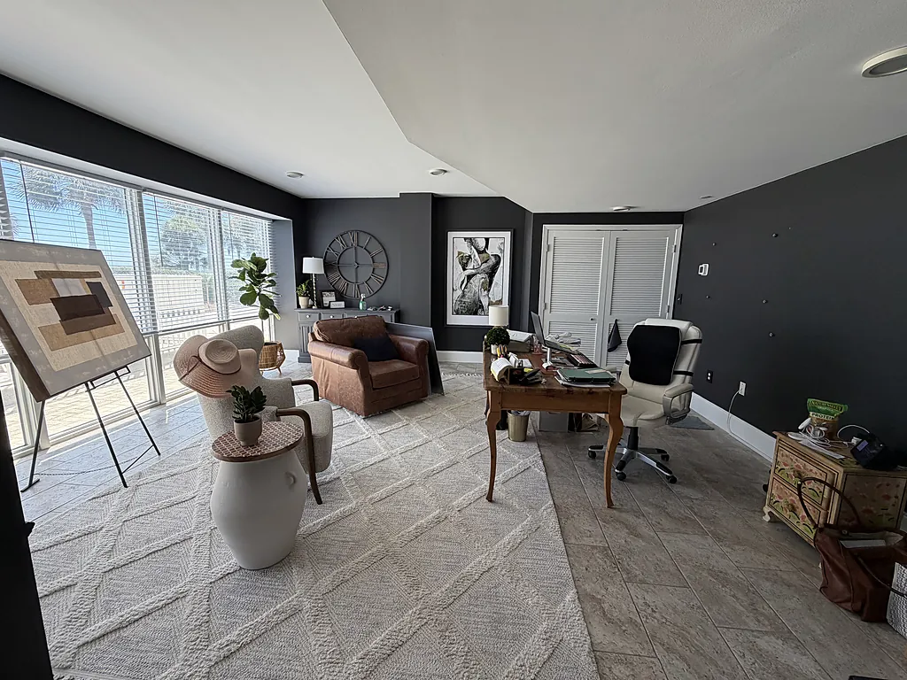 Gulf-front living room in Destin, Florida with charcoal walls, a white ceiling and freshly painted trim